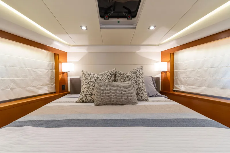  Yacht Photos Pics Luxurious bedroom interior of 2017 Prestige 500 yacht with elegant bedding and ambient lighting.