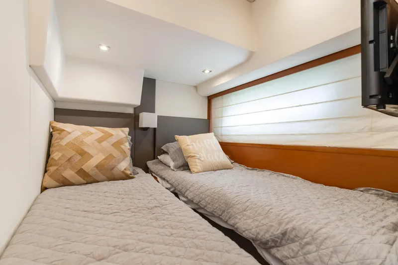  Yacht Photos Pics Cozy twin cabin in 2017 Prestige 500 yacht with modern decor and soft lighting.