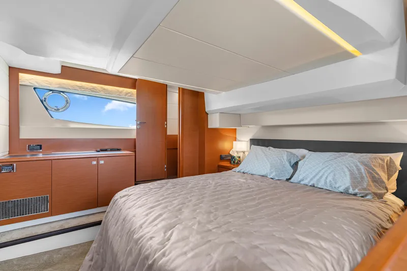  Yacht Photos Pics Luxurious cabin interior of 2017 Prestige 500 yacht with elegant bedding and wooden accents.