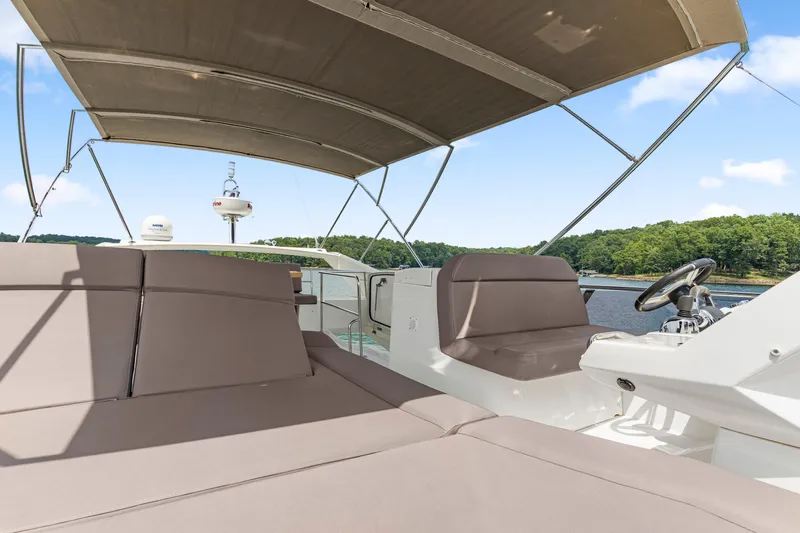  Yacht Photos Pics 2017 Prestige 500 yacht with spacious deck and canopy, cruising on a serene lake.