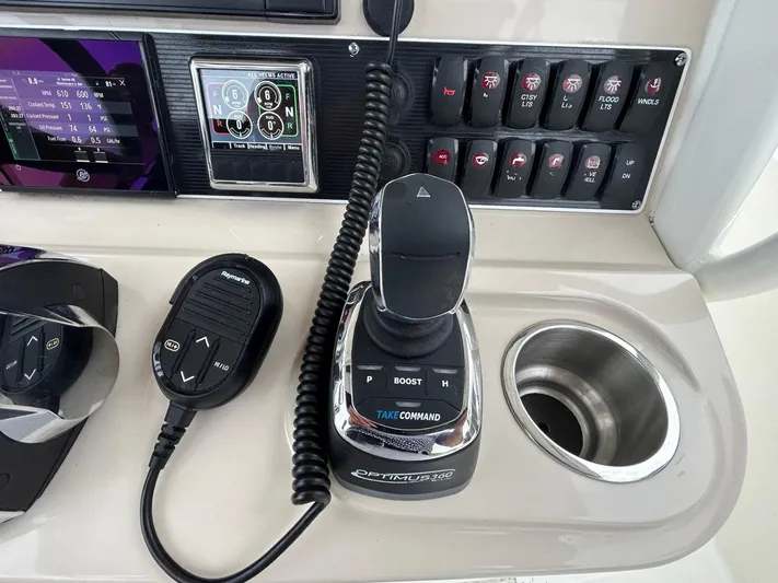  Yacht Photos Pics Control panel of a 2022 Boston Whaler 27 Dauntless boat with joystick and microphone.