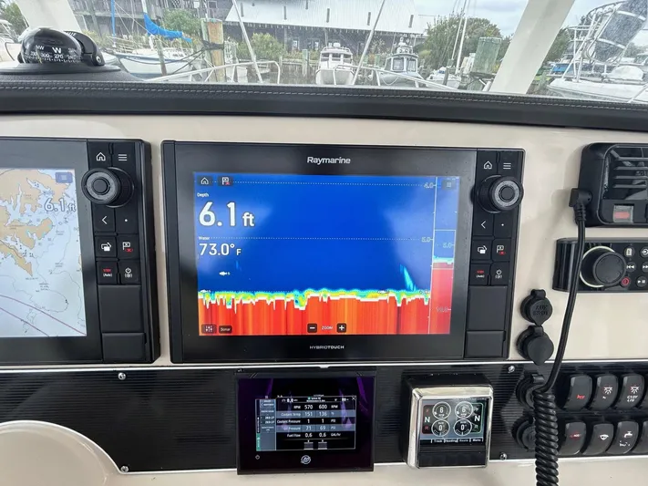  Yacht Photos Pics Control panel of a 2022 Boston Whaler 27 Dauntless with Raymarine display showing depth and temperature.