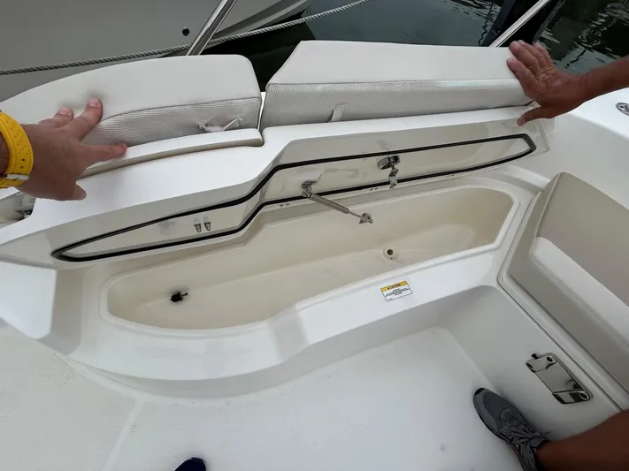 Yacht Photos Pics 2022 Boston Whaler 27 Dauntless boat storage compartment with open lid, showcasing interior space.