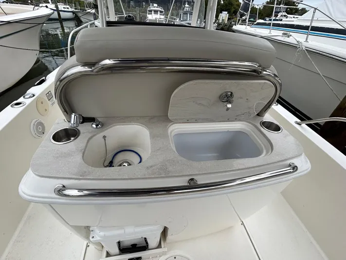  Yacht Photos Pics 2022 Boston Whaler 27 Dauntless boat sink and counter area with stainless steel fixtures.