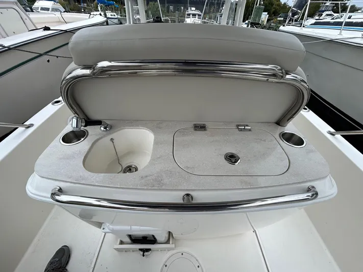  Yacht Photos Pics 2022 Boston Whaler 27 Dauntless boat console with sink and storage compartments.
