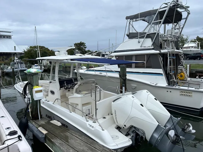  Yacht Photos Pics 2022 Boston Whaler 27 Dauntless boat docked at marina, featuring twin outboard engines.