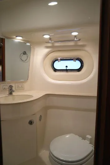  Yacht Photos Pics 2006 Tiara Yachts 3600 Sovran bathroom with porthole, sink, and toilet.