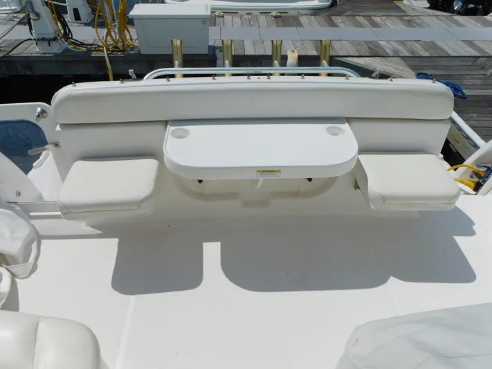  Yacht Photos Pics 2006 Tiara Yachts 3600 Sovran cockpit with white seating and table at dock.