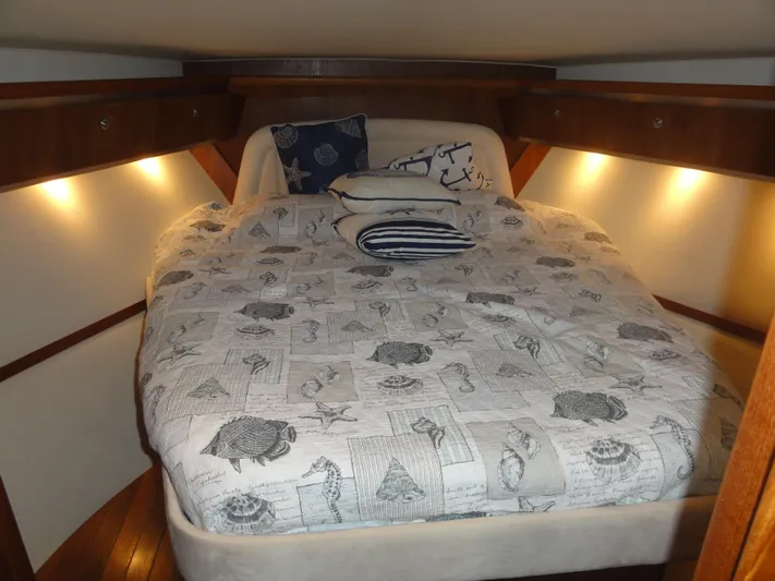  Yacht Photos Pics 2006 Tiara Yachts 3600 Sovran cabin with cozy bed and nautical-themed bedding.