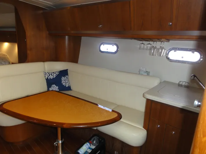  Yacht Photos Pics 2006 Tiara Yachts 3600 Sovran interior with cozy seating and elegant wooden table.