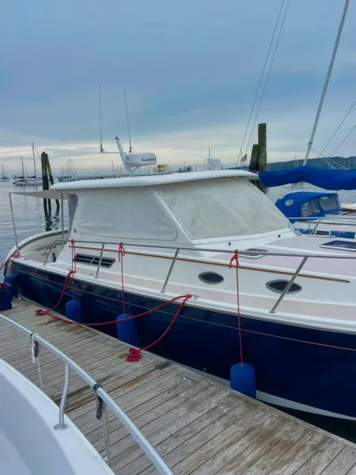 Dragonfly Yacht Photos Pics 2007 Back Cove 33 boat docked, blue hull, white cabin, moored with red ropes and blue fenders.