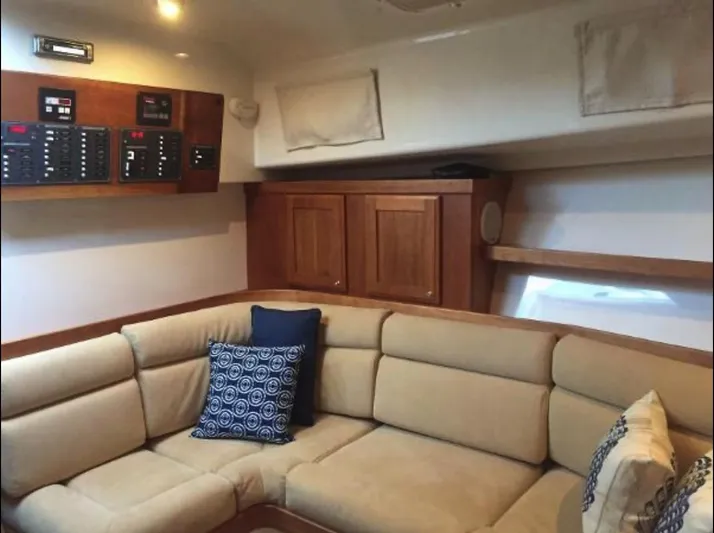 Dragonfly Yacht Photos Pics Interior of 2007 Back Cove 33 yacht with beige seating and wooden cabinetry.