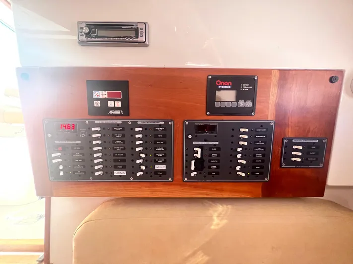 Dragonfly Yacht Photos Pics Electrical control panel on a 2007 Back Cove 33 boat, featuring various switches and displays.
