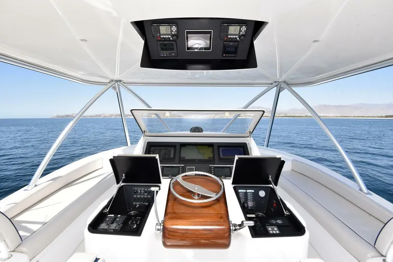 Lena Maria Yacht Photos Pics Helm of 2020 Viking 58 Convertible yacht with advanced navigation systems on open sea.