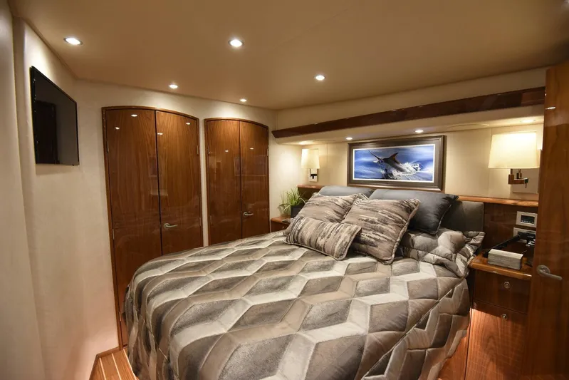 Lena Maria Yacht Photos Pics Luxurious bedroom interior of 2020 Viking 58 Convertible yacht with modern decor and cozy bedding.