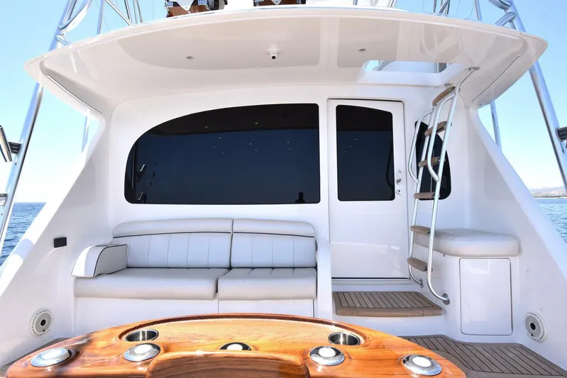 Lena Maria Yacht Photos Pics 2020 Viking 58 Convertible yacht interior with seating and ladder, featuring sleek design and wood accents.