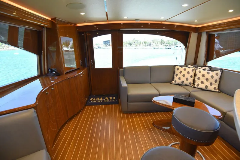 Lena Maria Yacht Photos Pics Luxurious interior of 2020 Viking 58 Convertible yacht with elegant wood finishes and modern seating.
