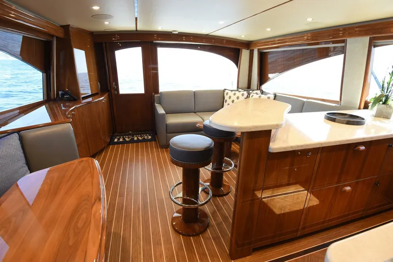 Lena Maria Yacht Photos Pics Luxurious interior of 2020 Viking 58 Convertible yacht with elegant wood finishes and modern seating.