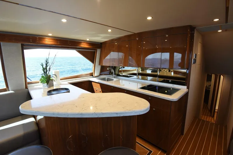 Lena Maria Yacht Photos Pics Luxurious kitchen interior of 2020 Viking 58 Convertible yacht with ocean view.