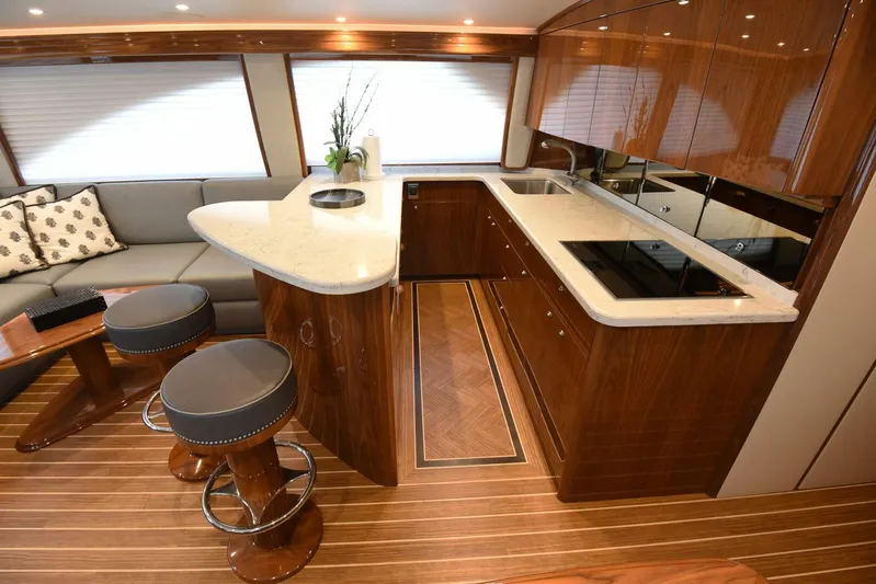Lena Maria Yacht Photos Pics Luxurious interior of 2020 Viking 58 Convertible yacht with modern kitchen and seating area.
