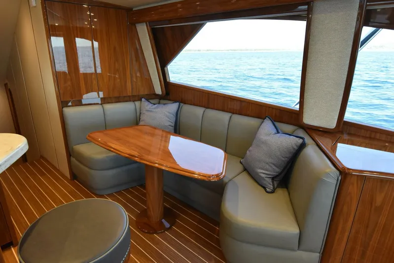 Lena Maria Yacht Photos Pics Luxurious interior of 2020 Viking 58 Convertible yacht with elegant seating and ocean view.