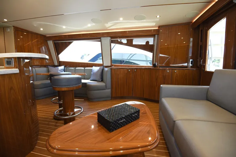 Lena Maria Yacht Photos Pics Luxurious interior of 2020 Viking 58 Convertible yacht with elegant wood finishes and modern seating.