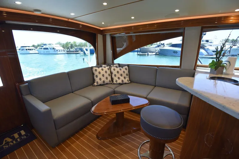 Lena Maria Yacht Photos Pics Luxurious interior of 2020 Viking 58 Convertible yacht with elegant seating and waterfront view.