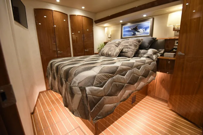 Lena Maria Yacht Photos Pics Luxurious bedroom interior of 2020 Viking 58 Convertible yacht with elegant bedding and wood finishes.