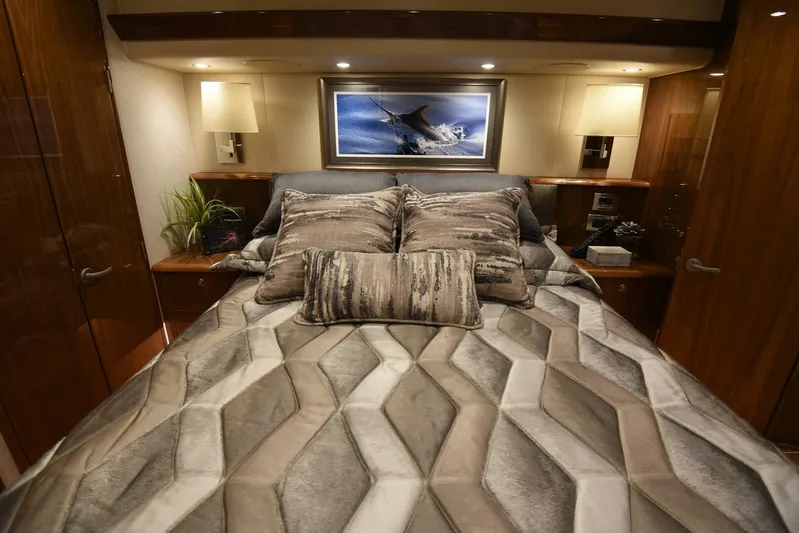 Lena Maria Yacht Photos Pics Luxurious bedroom interior of 2020 Viking 58 Convertible yacht with geometric bedding and elegant lighting.