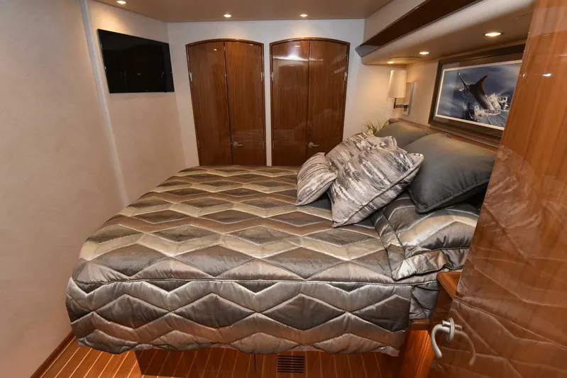 Lena Maria Yacht Photos Pics Luxurious bedroom interior of 2020 Viking 58 Convertible yacht with elegant bedding and wood finishes.