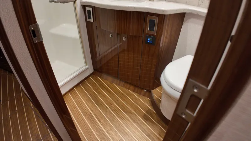 Lena Maria Yacht Photos Pics Luxurious bathroom in 2020 Viking 58 Convertible yacht with wood flooring and modern fixtures.