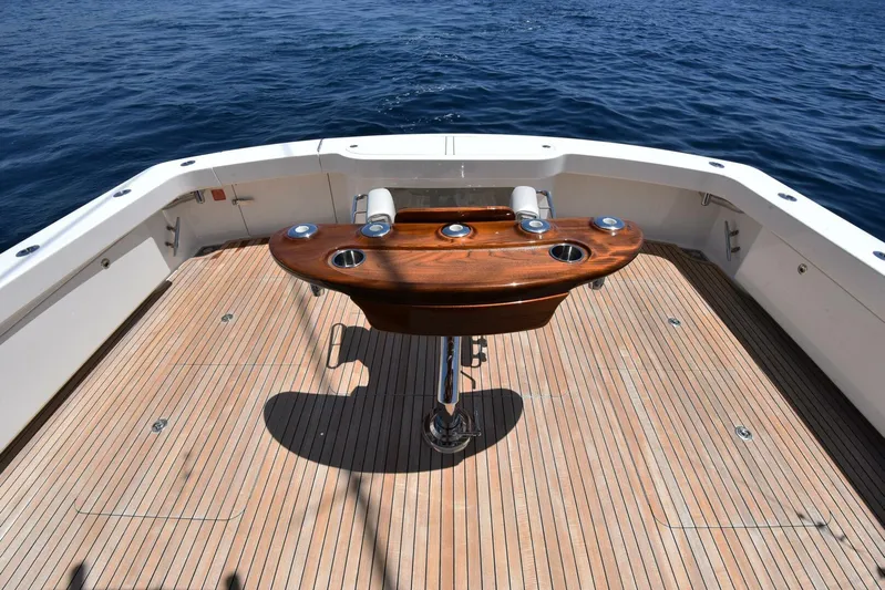 Lena Maria Yacht Photos Pics 2020 Viking 58 Convertible yacht deck with wooden table, ocean view.