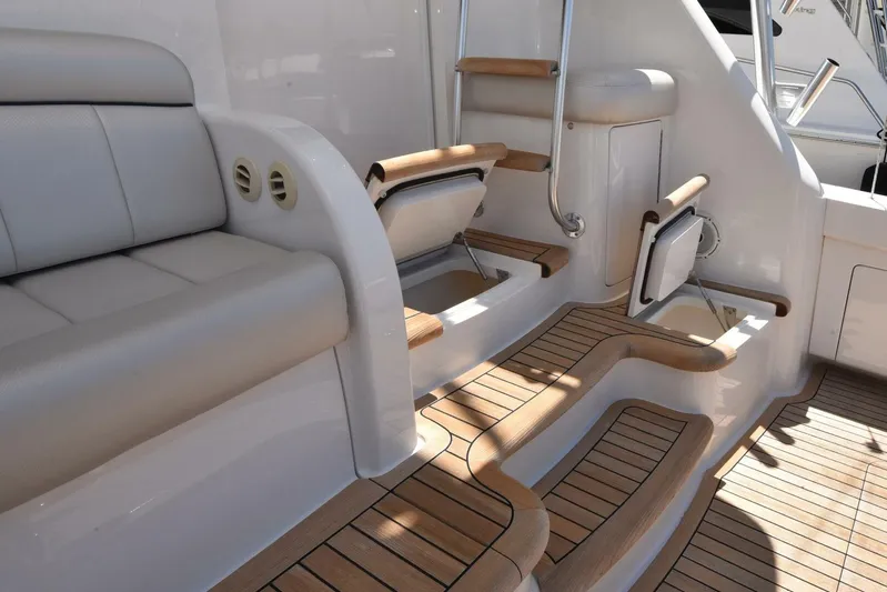 Lena Maria Yacht Photos Pics 2020 Viking 58 Convertible yacht interior with teak steps and cushioned seating.