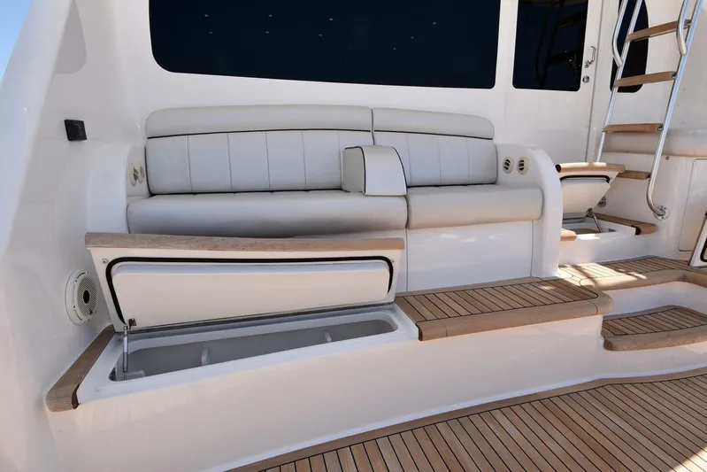 Lena Maria Yacht Photos Pics 2020 Viking 58 Convertible yacht interior with cushioned seating and wooden flooring.