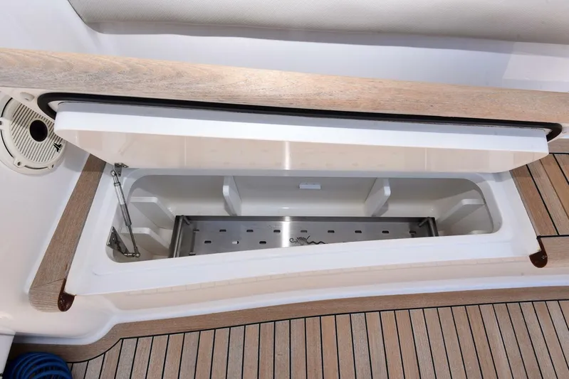 Lena Maria Yacht Photos Pics Open storage compartment on 2020 Viking 58 Convertible yacht with wooden deck.