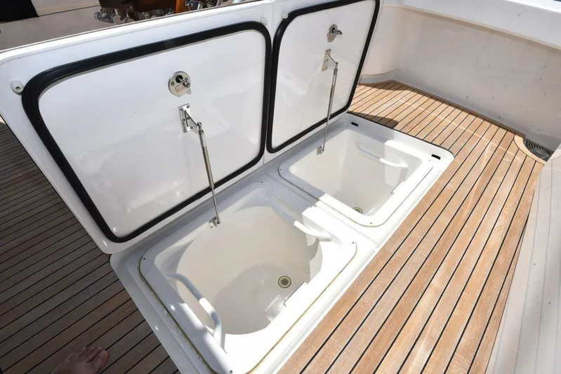 Lena Maria Yacht Photos Pics Open storage compartments on 2020 Viking 58 Convertible yacht deck.