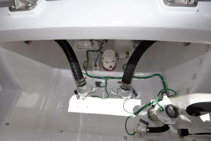 Lena Maria Yacht Photos Pics Engine compartment of 2020 Viking 58 Convertible yacht, showing hoses and mechanical components.