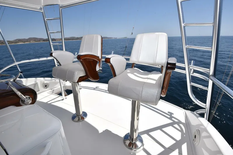 Lena Maria Yacht Photos Pics Two white captain's chairs on a 2020 Viking 58 Convertible yacht deck.