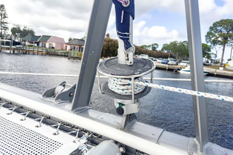 &Eacute;toile De Mer Yacht Photos Pics Sailing equipment on a 2002 Leopard 42 catamaran, docked near waterfront homes.