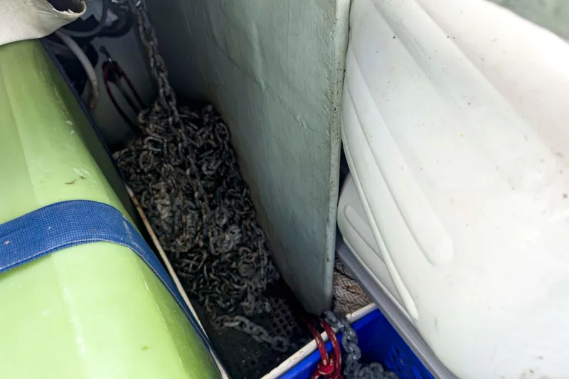 &Eacute;toile De Mer Yacht Photos Pics Storage compartment on a 2002 Leopard 42 boat with chains and equipment.