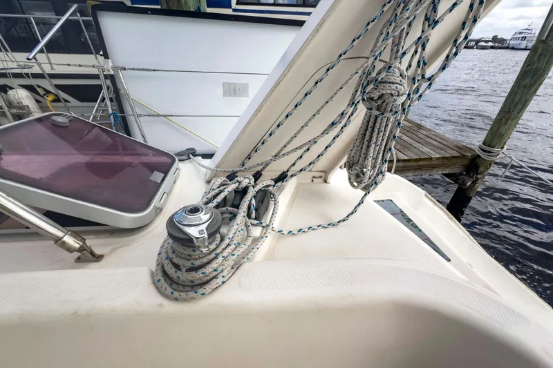 &Eacute;toile De Mer Yacht Photos Pics Leopard 42 sailboat deck with ropes and winch, docked by the water.