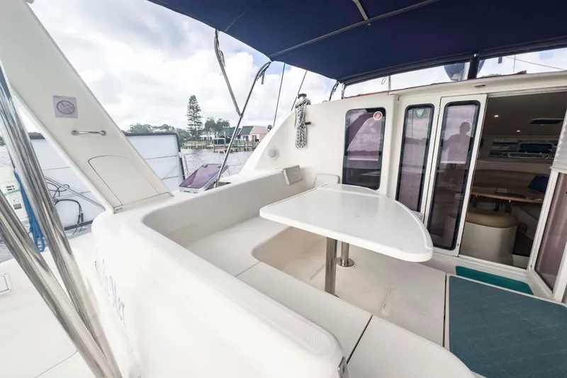 &Eacute;toile De Mer Yacht Photos Pics 2002 Leopard 42 yacht with outdoor seating and table, docked at marina.