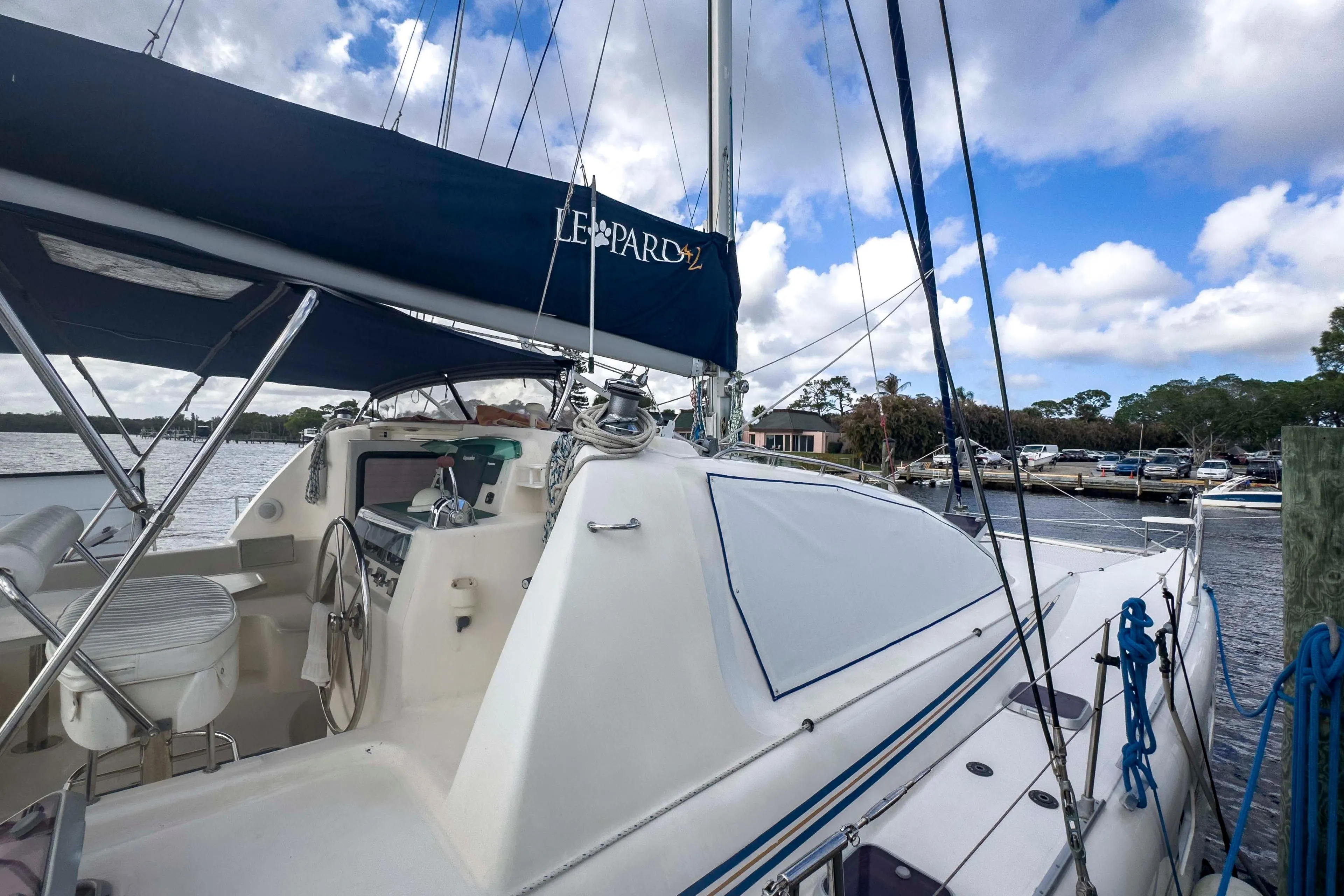 Sailing yacht Leopard 42, 2002 model, docked at marina under blue sky.