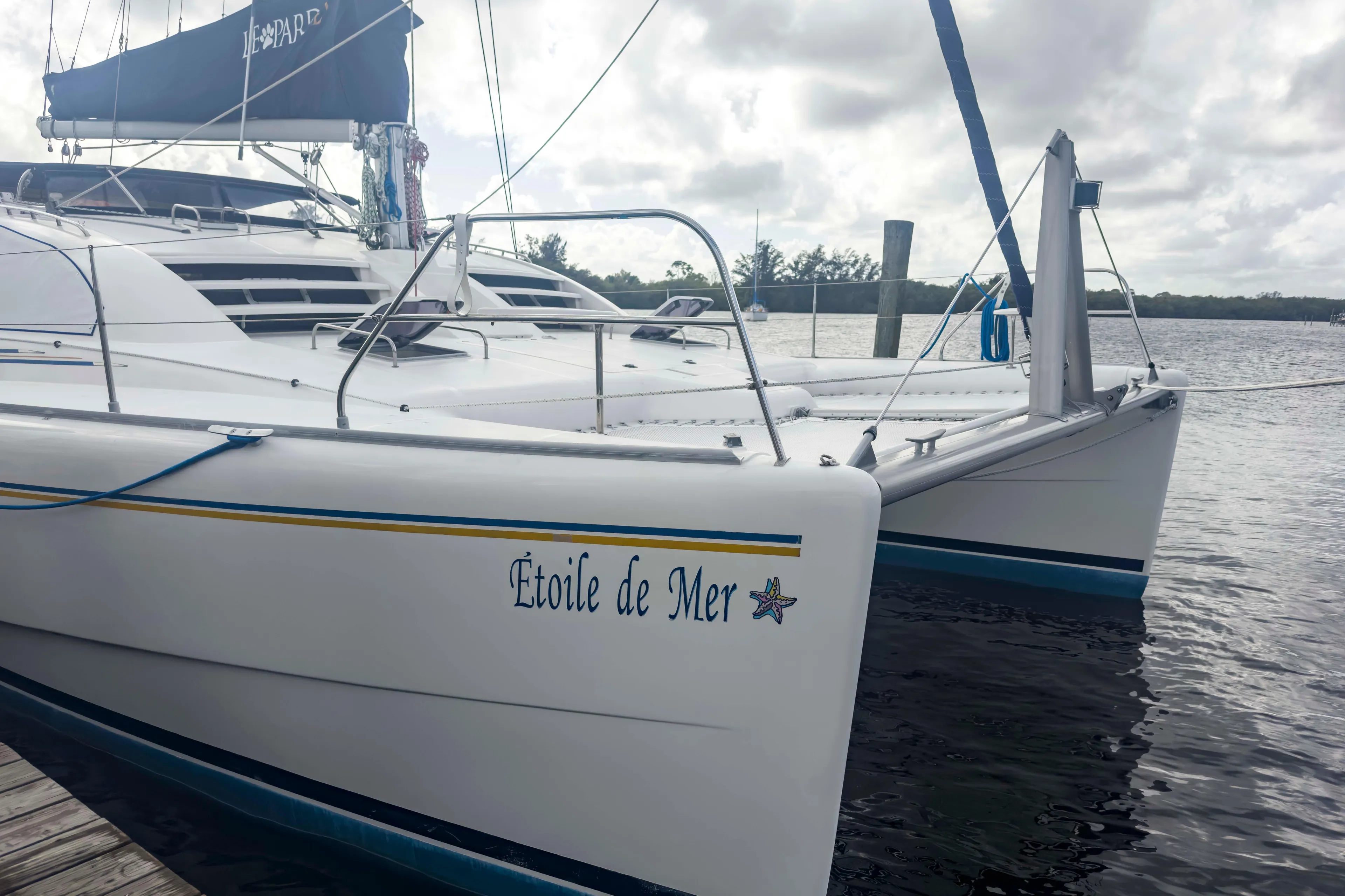 Leopard 42 catamaran "Étoile de Mer" docked, 2002 model, on a cloudy day.