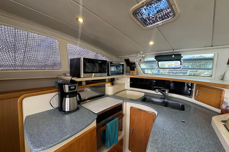 &Eacute;toile De Mer Yacht Photos Pics Modern kitchen interior of 2002 Leopard 42 yacht with appliances and ample counter space.
