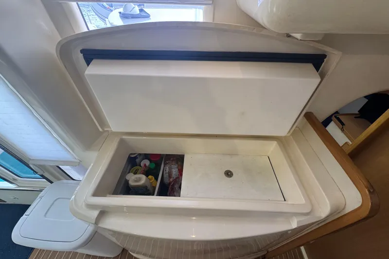 &Eacute;toile De Mer Yacht Photos Pics Interior view of a 2002 Leopard 42 yacht's storage compartment with various items.