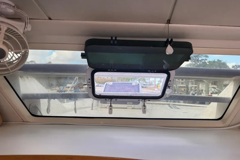 &Eacute;toile De Mer Yacht Photos Pics Interior view of a 2002 Leopard 42 yacht window with fan and open hatch.