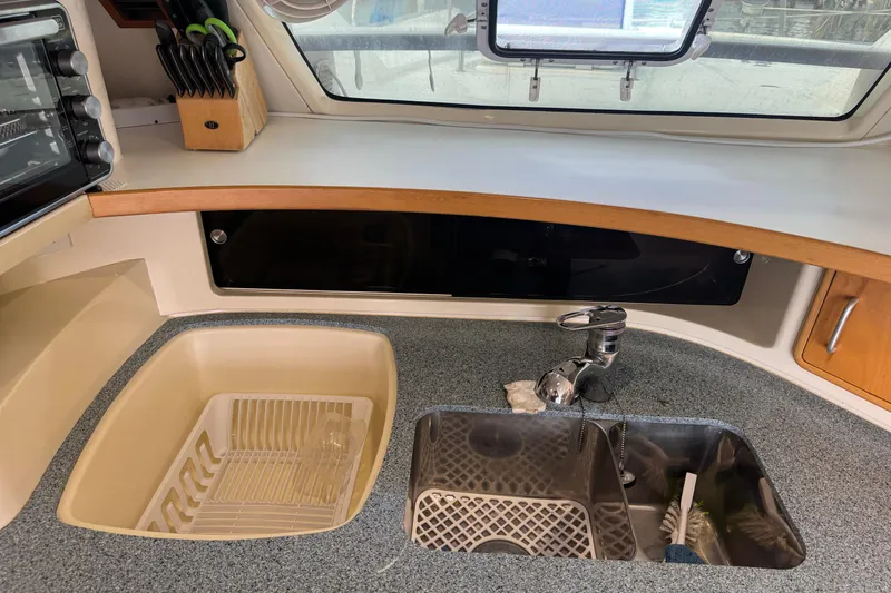&Eacute;toile De Mer Yacht Photos Pics Kitchen area of a 2002 Leopard 42 yacht with sink and countertop.