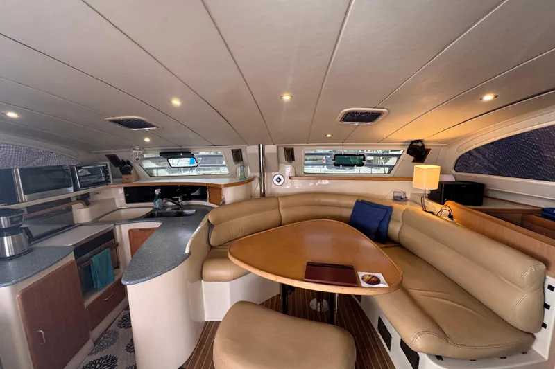 &Eacute;toile De Mer Yacht Photos Pics Luxurious interior of a 2002 Leopard 42 yacht with modern kitchen and cozy seating area.
