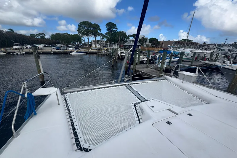 &Eacute;toile De Mer Yacht Photos Pics Catamaran Leopard 42, 2002 model, docked at marina with clear sky and boats.